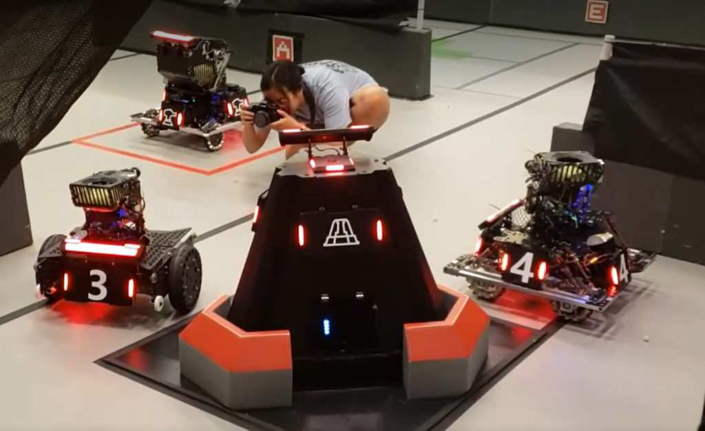 Purdue RoboMaster robots arranged together on the field.