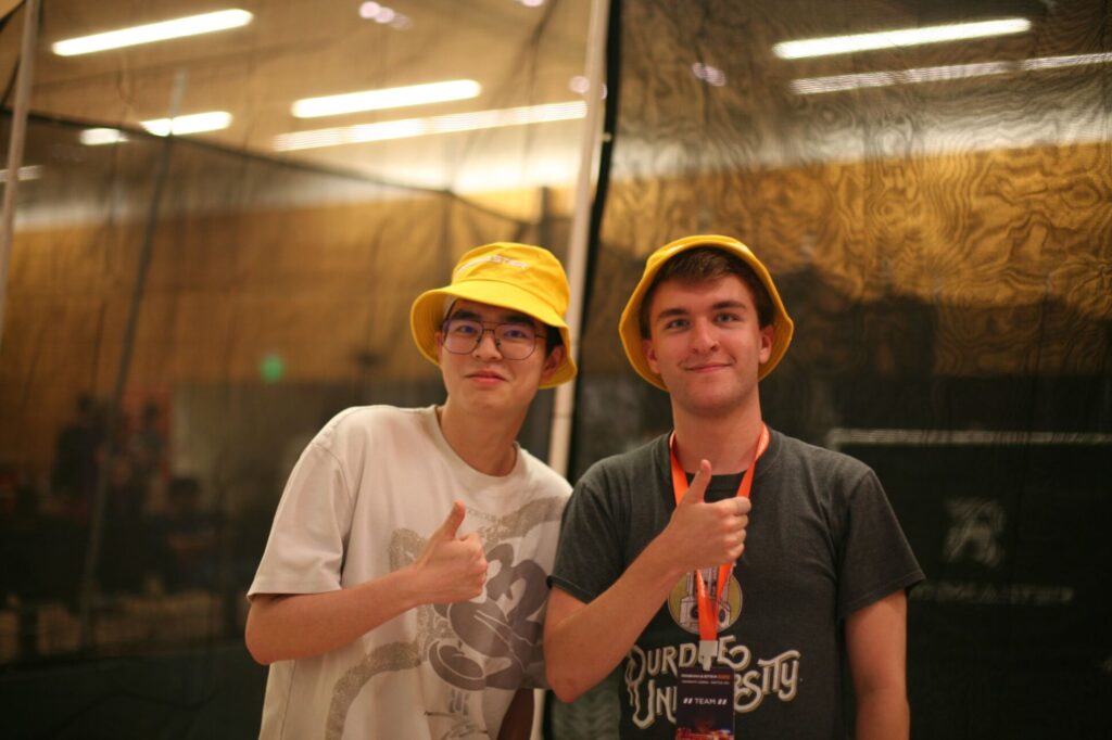 Team member wearing a yellow hat at the competition.